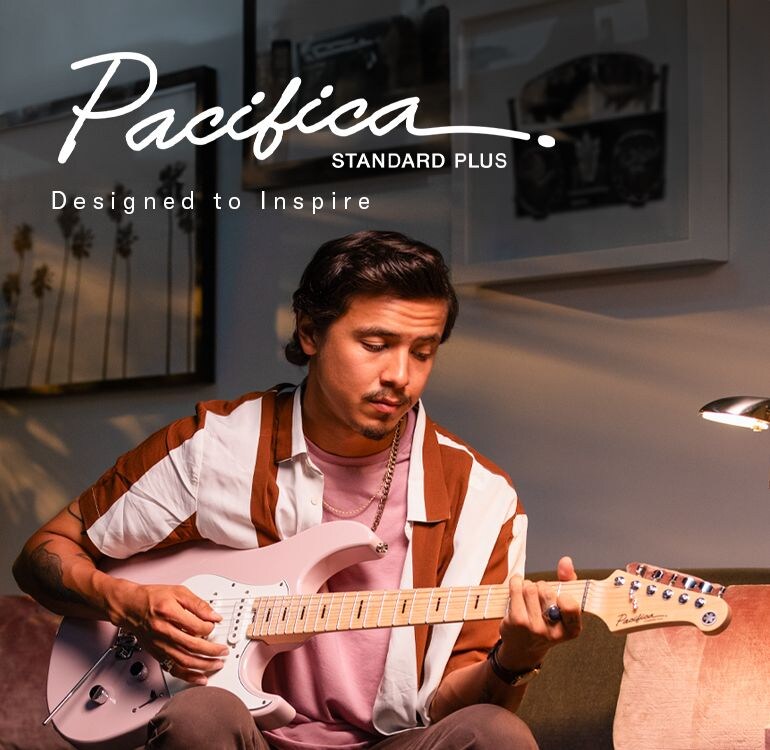 Pacifica professional logo & designed to inspire. Male on sofa playing Standard Plus Ash Pink (maple).
