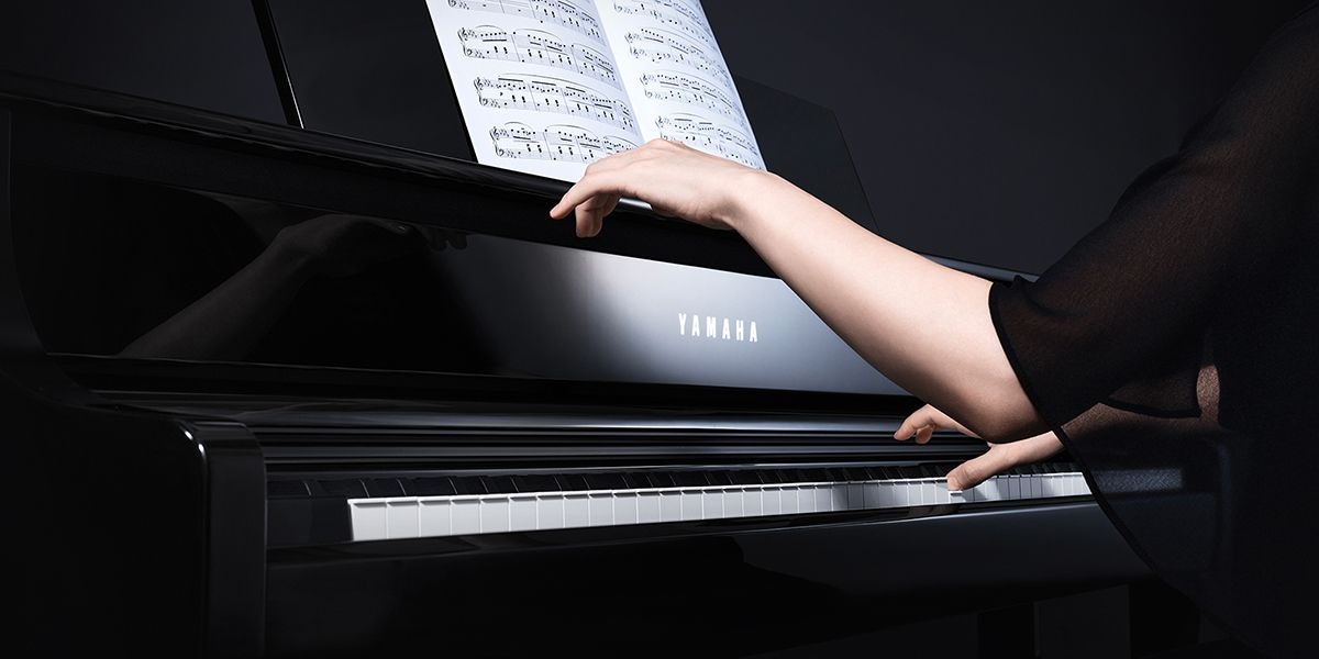 A person playing Yamaha Clavinova CLP-875PE