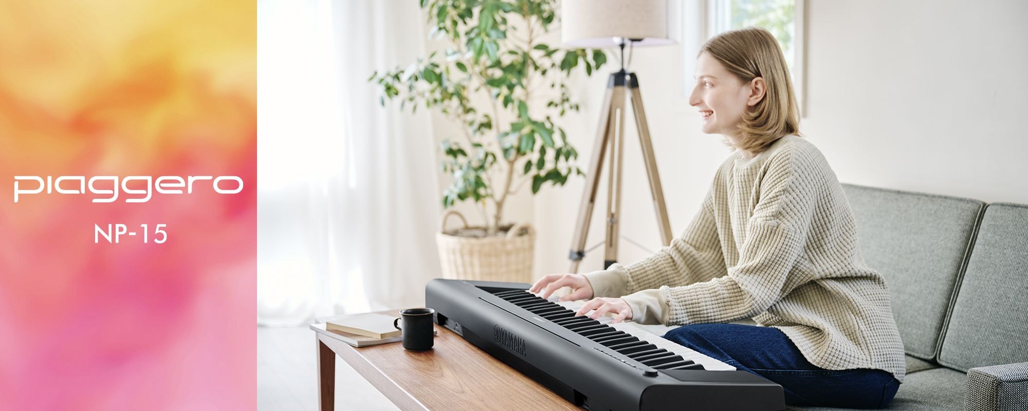 A person sitting on the sofa playing the Piaggero on a coffee table