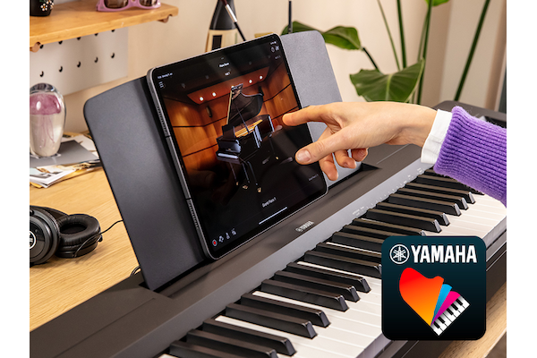 The Yamaha “Smart Pianist” app icon, together with a tablet placed on the music stand of the P-145