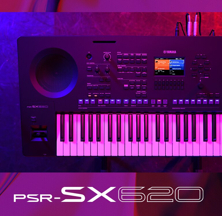 Top view of a PSR-SX620 keyboard under stage lighting.