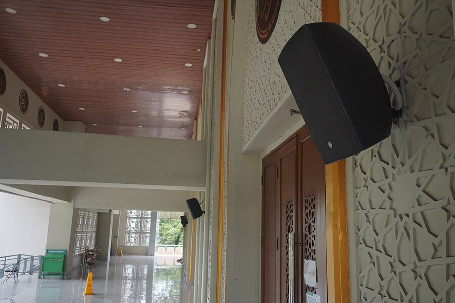 A spacious indoor corridor with VXS8 surface mount loudspeakers installed.