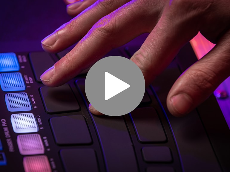 Close-up of index finger pressing down on FGDP-50 snare pad and video playback icon