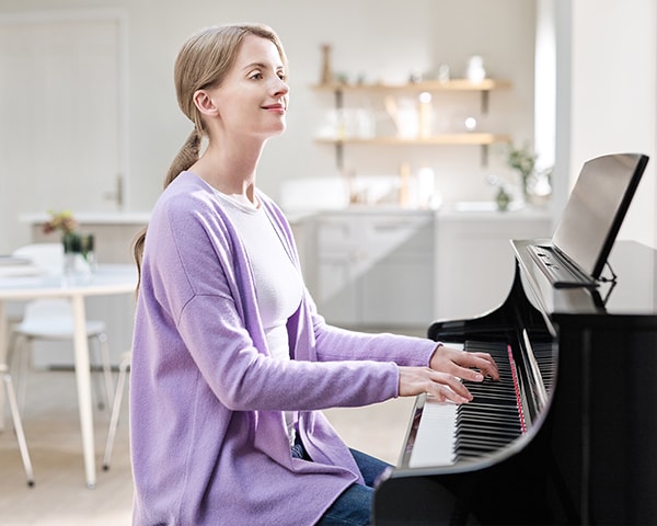 A person playing Yamaha Clavinova CLP-875PE with a pleasant feeling