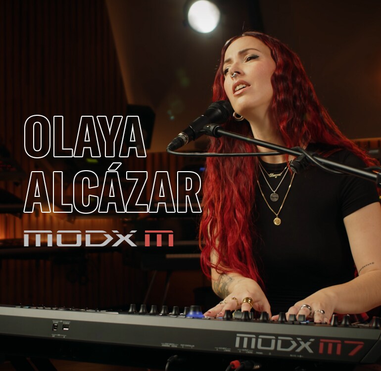 Visual of Olaya Alcázar playing a synthesizer in a performance scene