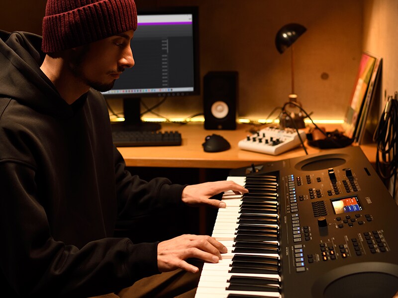 Une personne jouant sur un clavier PSR-SX620 dans un studio maison.