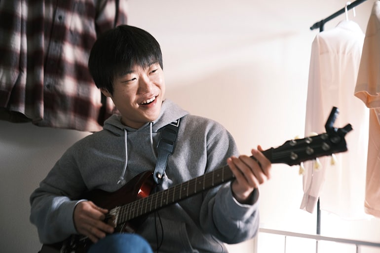 Un homme essayant de jouer de la guitare pour la première fois